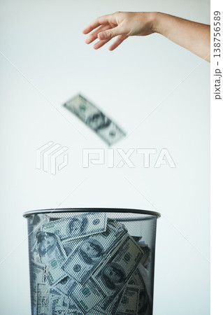 Dustbin, money or bills with finance, inflation or debt with bankruptcy, trash or global recession. Waste bucket, cash or economy issues with fraud, corruption or value decline on a studio background 138756589