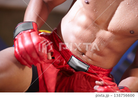 Six pack, sweating body or mma boxer with fitness or strong abs in workout in a boxing ring or gym. Topless man, fighter closeup or tired sports athlete with stomach or muscle in exercise or training 138756600