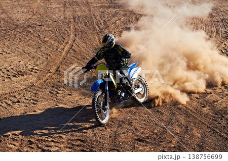 Man, motorcycle and bike dust cloud as professional rider in action danger competition, fearless or race. Male person, transportation or fast speed dirt adventure or rally, challenge gear or driving 138756699