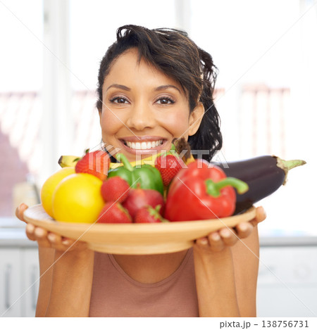 Portrait, cooking and vegetables with a woman in the kitchen of her home for nutrition, diet or meal preparation. Face, ingredients and a recipe for health food with a young person in her apartment 138756731