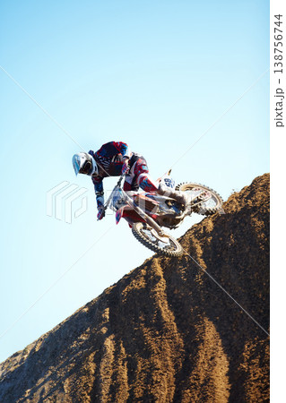 Man, motorcycle and dirt bike on hill professional rider in action danger competition, fearless or race. Male person, transportation or fast mountain adventure or blue sky, rally challenge or driving Man, motorcycle and dirt bike on hill professional rider in action danger competition, fearless or race. Male person, transportation or fast mountain adventure or blue sky, rally challenge or driving 138756744