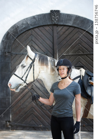 Portrait, horse and happy woman with animal at ranch in the countryside outdoor. Equestrian, rider and person in helmet with a pet stallion, confidence and standing together for hobby or summer sport 138756746