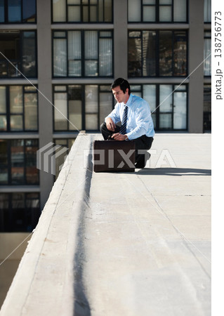 Businessman, suicide or roof and thinking, depression and mental health with suitcase outdoor in city. Professional, person or employee and stress on rooftop of building with anxiety, risk and crisis Businessman, suicide or roof and thinking, depression and mental health with suitcase outdoor in city. Professional, person or employee and stress on rooftop of building with anxiety, risk and crisis 138756773