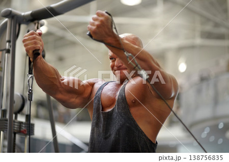 Body builder, strength exercise and man in a gym with power, weightlifting machine and workout. Muscle, strain and strong male athlete with training for bodybuilder fitness and wellness for sport Body builder, strength exercise and man in a gym with power, weightlifting machine and workout. Muscle, strain and strong male athlete with training for bodybuilder fitness and wellness for sport 138756835