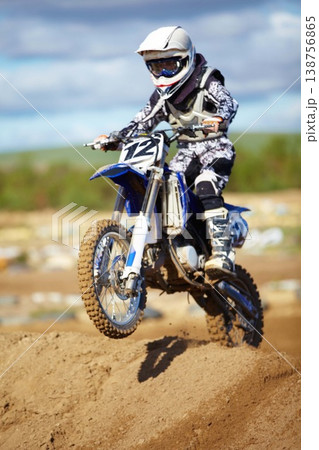 Man, motorcycle and bike hill jump as professional rider in action danger competition, fearless or race. Male person, transportation or fast speed dirt adventure or rally, challenge gear or driving 138756865