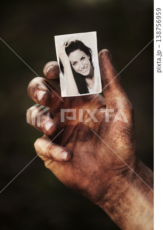Hand, holding picture of woman and portrait, retro nostalgia or remember memory of family or partner isolated on background in studio. Closeup, black and white photo of wife and dirty fingers of man 138756959