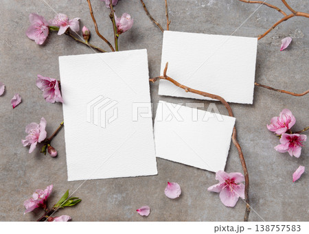 Blank wedding cards suite mockup with pink cherry blossoms and twigs on grey stone. Spring stationery 138757583