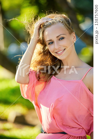 Young woman in pink top enjoying nature outdoors Young woman in pink top enjoying nature outdoors 138757600