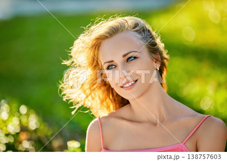 Beautiful woman in pink top posing in sunlight Beautiful woman in pink top posing in sunlight 138757603