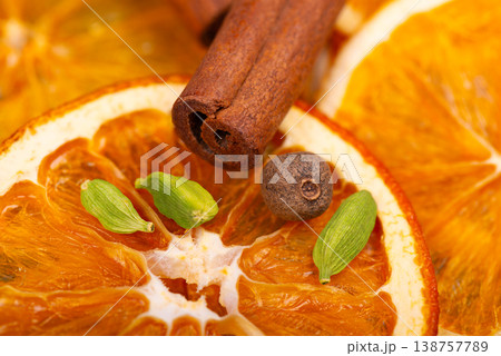 Dry orange slices with cinnamon sticks, allspice berries and cardamom seeds. 138757789