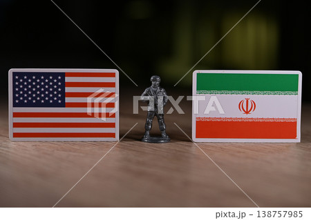 A tin soldier on the background of the flags of the United States and Iran. A tin soldier on the background of the flags of the United States and Iran. 138757985