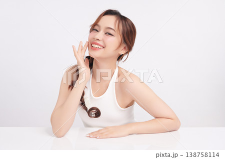 A beautiful young Asian woman with clean, fresh skin against a white background. Skincare, facial treatment, cosmetology, beauty, and spa. An elegant portrait of an Asian woman. A beautiful young Asian woman with clean, fresh skin against a white background. Skincare, facial treatment, cosmetology, beauty, and spa. An elegant portrait of an Asian woman. 138758114