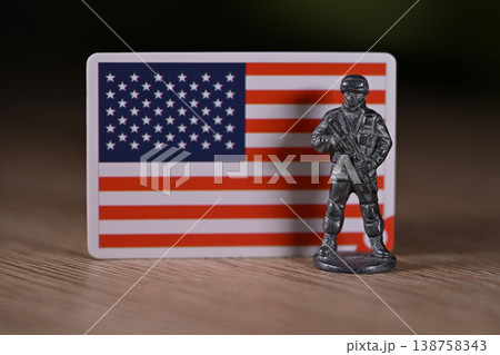 A tin soldier on the background of the flag of the United States. 138758343