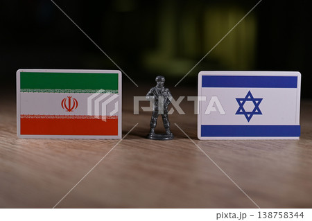 A tin soldier on the background of the flags of Iran and Israel. 138758344