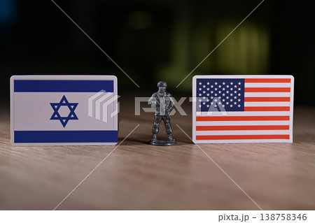 A tin soldier on the background of the flags of the United States and Israel. 138758346