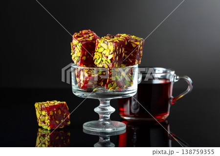 Turkish delights on a black reflective background. Turkish delights on a black reflective background. 138759355