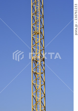 Yellow Construction Crane Tower Against Blue Sky Yellow Construction Crane Tower Against Blue Sky 138761153