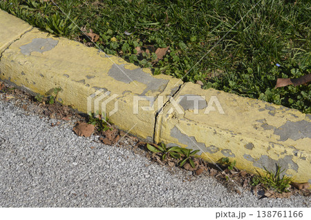 Weathered Yellow Concrete Curb with Cracked Texture Weathered Yellow Concrete Curb with Cracked Texture 138761166
