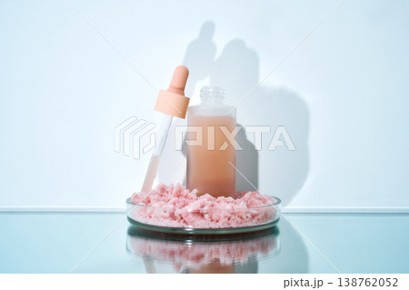 Skincare serum formulation in petri dish with pink salt 138762052