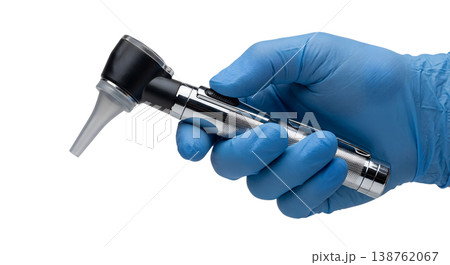Gloved hand wearing a blue nitrile glove holding a medical otoscope with a speculum attachment, representing ear examination and clinical diagnostics Gloved hand wearing a blue nitrile glove holding a medical otoscope with a speculum attachment, representing ear examination and clinical diagnostics 138762067