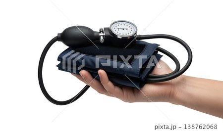 Hand holding a manual aneroid blood pressure monitor (sphygmomanometer) with a gauge and inflation bulb, representing hypertension screening and vital signs 138762068
