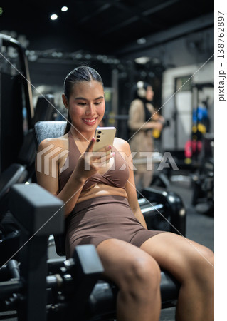Thai Fitness Influencer Tracking Progress on Smartphone at Gym Training Done Concept Thai Fitness Influencer Tracking Progress on Smartphone at Gym Training Done Concept 138762897