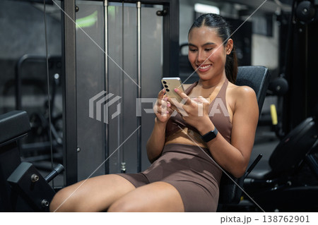Thai Fitness Influencer Tracking Progress on Smartphone at Gym Gym Training Done Concept Thai Fitness Influencer Tracking Progress on Smartphone at Gym Gym Training Done Concept 138762901