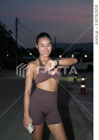 Smiling Thai Fitness Influencer Tracking Night Run Progress Modern Active Lifestyle Concept Smiling Thai Fitness Influencer Tracking Night Run Progress Modern Active Lifestyle Concept 138762938