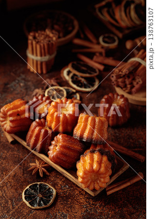 Cinnamon cakes in wooden dish on a brown background. 138763107