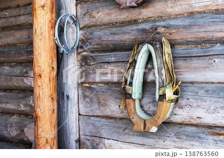 Old horse harness. Faded horse collar displayed on aged barn wall with weathered wood 138763560