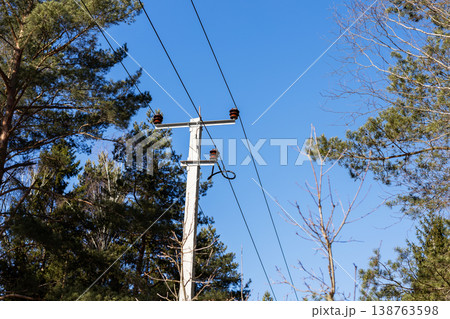 Rural power infrastructure. Ceramic hardware and tensioned cables in countryside setting 138763598