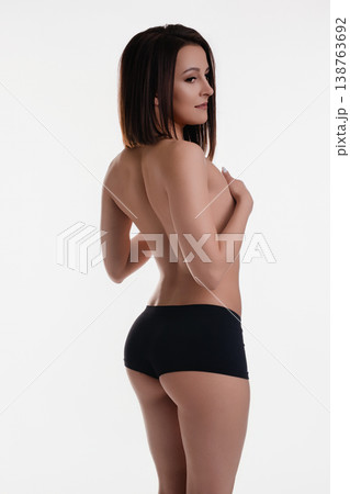 Topless brunette in black panties, seductive back pose Topless brunette in black panties, seductive back pose 138763692