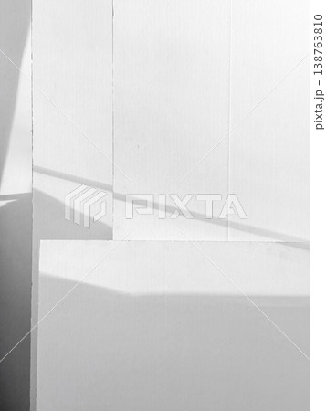 Bright light shines on white surface, shadows create distinct shapes and patterns. Varying layers with lines of light cutting across surface, simple beauty of light interacting with color and form Bright light shines on white surface, shadows create distinct shapes and patterns. Varying layers with lines of light cutting across surface, simple beauty of light interacting with color and form 138763810