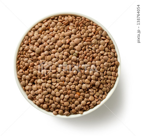 Bowl of brown lentils isolated on white background, top view 138764054