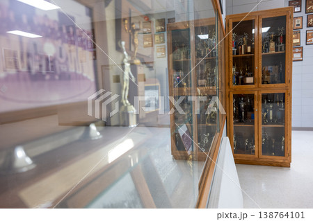 Trophy display showing sports achievements in a hall with glass cabinets for memorabilia 138764101