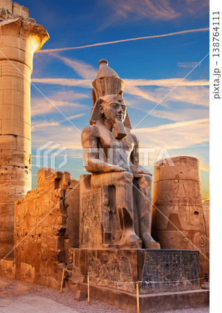 Sunset view of Ramesses II seated by the Luxor Temple entrance, Egypt Sunset view of Ramesses II seated by the Luxor Temple entrance, Egypt 138764111