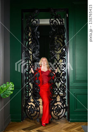 Stylish blonde lady strolling through ornate passageway Stylish blonde lady strolling through ornate passageway 138765415