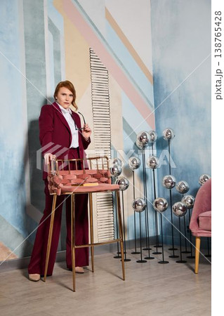 Selfassured female representative displays product collection gracefully Selfassured female representative displays product collection gracefully 138765428