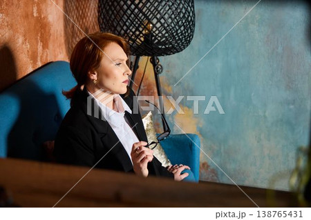 Thoughtful female professional preparing client session documentation Thoughtful female professional preparing client session documentation 138765431