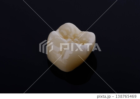 High-quality zirconia dental crown on white background. Dental ceramic crown professional dental lab High-quality zirconia dental crown on white background. Dental ceramic crown professional dental lab 138765469