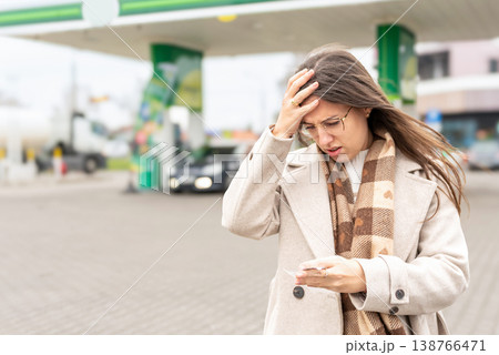 Fuel inflation concept woman shocked by gas receipt 138766471