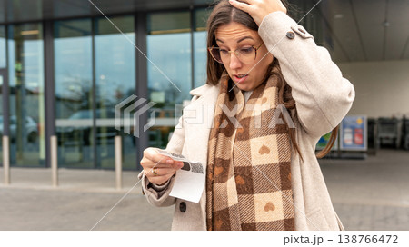 Young Woman Reacting to High Cost Grocery Receipt 138766472
