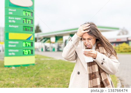Fuel inflation concept woman shocked by gas receipt Fuel inflation concept woman shocked by gas receipt 138766474
