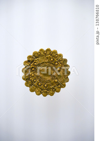 Isolated Ancient Round Gold Jewelry Artifact on White Background. High quality photo Isolated Ancient Round Gold Jewelry Artifact on White Background. High quality photo 138766810