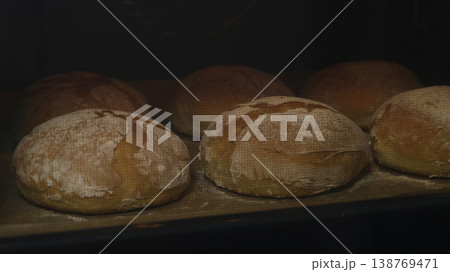 Warm Baked Breads On Shelf. Evening Bakery Emits Warm Light And Steam Warm Baked Breads On Shelf. Evening Bakery Emits Warm Light And Steam 138769471