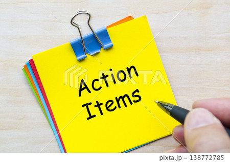 Action items written on yellow sticky note representing follow-up tasks and accountability. Action items written on yellow sticky note representing follow-up tasks and accountability. 138772785