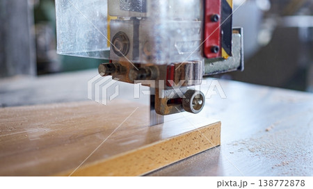 Bandsaw blade cutting wood in a woodworking workshop 138772878