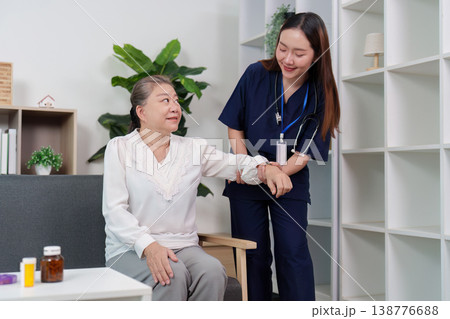 Nurse assisting elderly woman with mobility during visit Nurse assisting elderly woman with mobility during visit 138776688