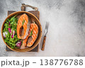 Grilled salmon steaks also known as red fish served in wooden bowl with fresh salad, light background with copy space 138776788