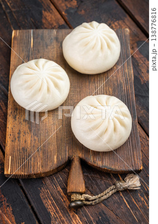 Nikuman steamed buns with dipping sauce and sesame seeds on rustic wooden background, Asian street food with copy space Nikuman steamed buns with dipping sauce and sesame seeds on rustic wooden background, Asian street food with copy space 138776816